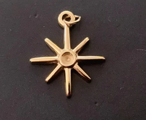 Close-up of golden stainless steel 8-pointed star pendant with center setting and jump ring