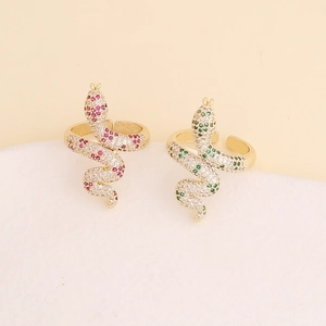 Close-up of snake rings in gold with pink and green micro-paved zircon crystals