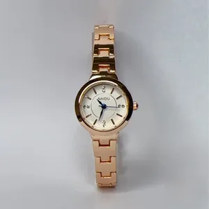 Close-up of rose gold watch band with H-shaped metal links and jewelry clasp detail