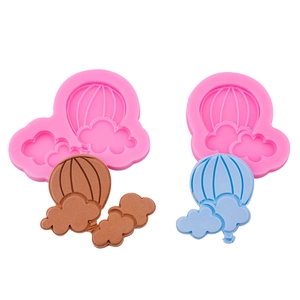 Pink silicone molds for hot air balloon and cloud shapes with finished clay models