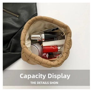Quilted puffer makeup bag in khaki showing large capacity for cosmetics and phone