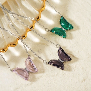 Three dainty butterfly necklaces with sparkling green, purple and pink zircon pendants