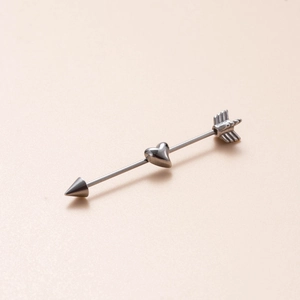 Close-up of stainless steel industrial barbell with heart-shaped slider and arrow ends