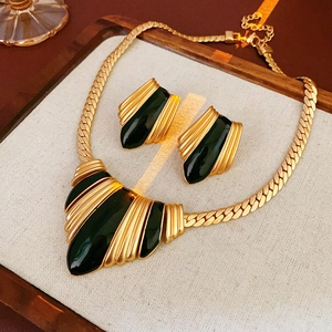 French vintage style gold necklace set with black enamel inlay on linen display tray