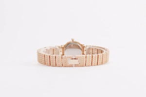 Polished back view of luxury rose gold women watch with textured metal link bracelet