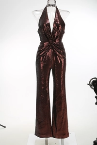 Detail of burgundy sequin jumpsuit featuring a deep V-neck and twisted waist design