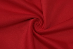 Macro shot of dark red fabric showing fine texture and draped spiral folds on summer set
