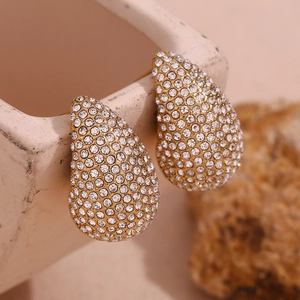Macro detail of teardrop earrings with pave-set white zircons and 18K gold plating