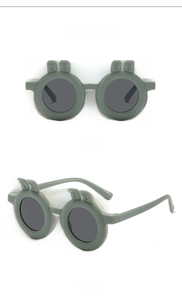 Detail view of olive green round kids sunglasses with cute rabbit ears and grey lenses