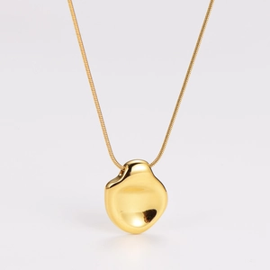 Macro shot of 18K gold irregular pebble pendant with polished mirror finish snake chain