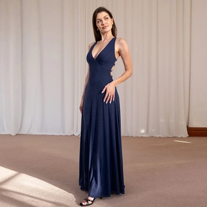 Detail of deep V-neckline and open back design on a navy blue sleeveless maxi dress