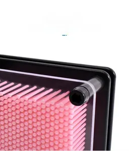 Macro shot of 3D pin art toy showing precise pink needle alignment and clear acrylic frame