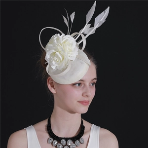 Detail of cream bridal fascinator hat with elegant faux flower and white feathers