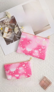 Pink quilted makeup bag set with butterfly patterns and round metal zipper details