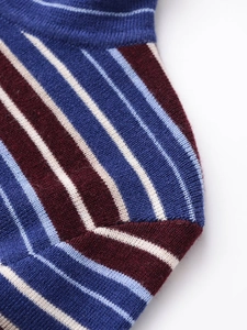 Macro shot of striped knit fabric detail showing texture in blue, red, and white