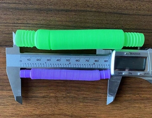 Detailed size measurement of green and purple colorful stretch tubes with digital caliper