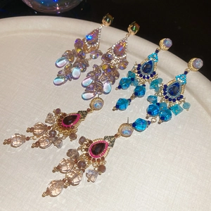 Detailed macro view of sparkling crystal tassel earrings with colorful teardrop stones