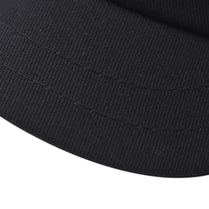 Detailed macro view of black twill cotton fabric with reinforced double stitching on visor