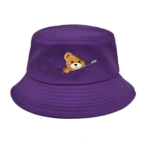 Detail of creative bear graphic emerging from zipper on purple cotton bucket hat