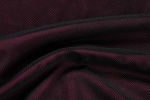 Detailaufnahme des burgunderroten Mesh-Gewebes und der feinen Strickstruktur am Kleid