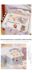 Close-up of house-shaped piggy bank showing coin slot and 3D cartoon bear decorations