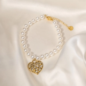 18K gold plated heart pendant pearl bracelet on elegant white silk background