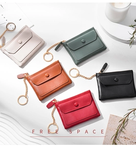 Detailed flat lay of mini PU leather wallets with keychains in five elegant colors