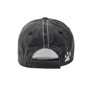 Detail of washed cotton baseball cap with white contrast stitching and paw print embroidery