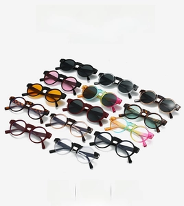 Flat lay of retro round sunglasses in various colors like tortoiseshell and red frames