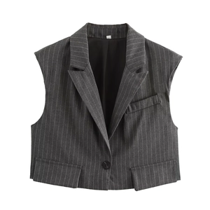 Detailed view of dark grey pinstripe vest featuring peak lapels and premium stitching