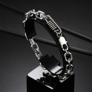 Industrial style stainless steel link bracelet with spring detail and lobster clasp on stand