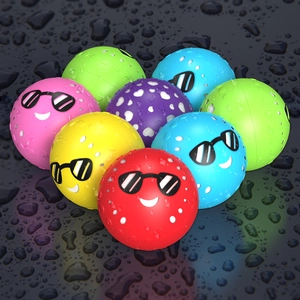 Colorful magnetic silicone water balloons with funny emoji faces on a wet surface