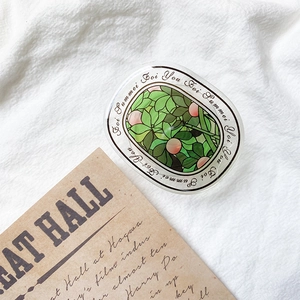Detailed macro view of an oval floral phone grip sticker on white fabric backdrop