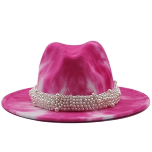 Detailed shot of pink tie-dye fedora hat with elegant white pearl decorative band