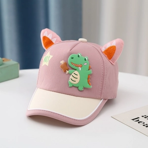 Close-up of pink baseball cap featuring 3D ears and a green cartoon dinosaur patch