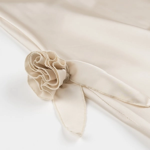 Elegant beige satin halter dress with 3D floral decoration and tie back detail