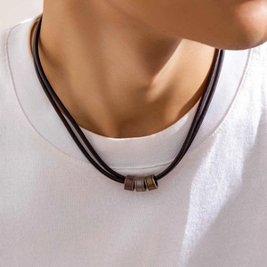 Detail of men's leather necklace featuring three vintage bronze cylindrical metal beads