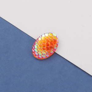 Detailed macro view of 13x18mm oval resin cabochon with iridescent orange fish scale texture