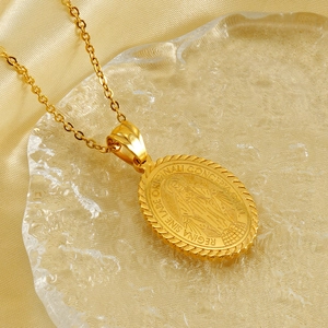 Golden Miraculous Medal pendant necklace with Virgin Mary relief on silk background