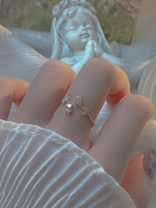Detail of elegant gold tulip ring with sparkling micro-pave crystals on model's hand