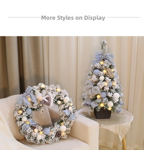 Detail of Nordic Christmas wreath and mini tree with blue bows and warm LED lights