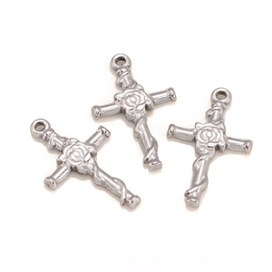 Macro view of stainless steel cross pendants with vintage rose and vine engravings