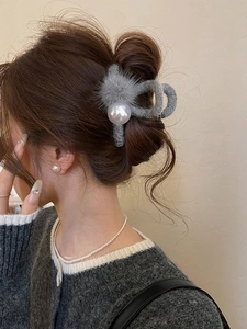 Side view of grey plush hair claw clip with large pearls on brunette hair