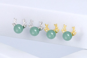 Detailed view of s925 silver and gold antler stud earrings with green aventurine stones