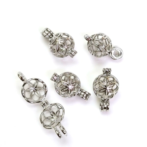 Close-up of silver hollow sphere pendant cage accessories for DIY jewelry making
