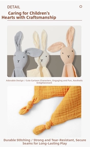 Detail view of cotton muslin baby comforter with bunny ears and knotted corner design
