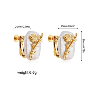 Detail view of gold flower earrings with white pearl base and product size specifications