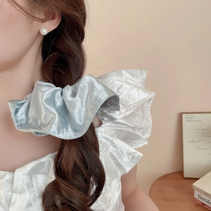 French style silver blue satin scrunchie shown in a hairstyle with silky texture and folds