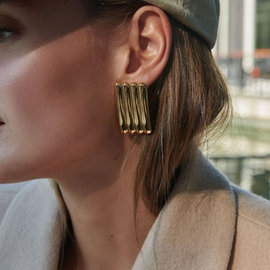Elegant 18k gold plated stainless steel striped earrings worn outdoors in natural light