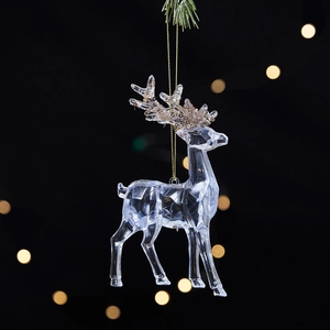 Transparent acrylic Christmas reindeer ornament with gold glitter antlers on black background